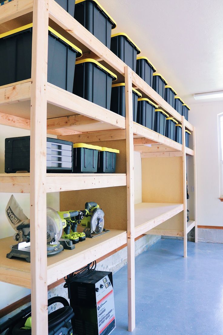 the shelves are filled with black containers and other items