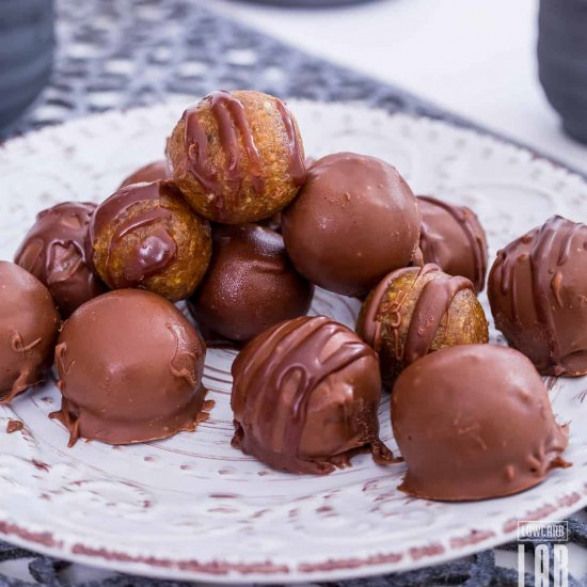 a plate full of chocolate truffles on a table