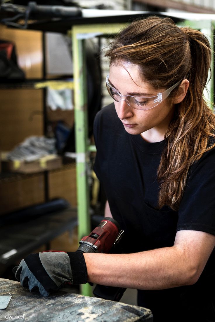 a woman wearing safety goggles working on something