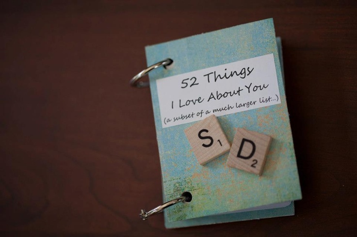 a notepad with two wooden blocks attached to it that says, 52 things i love about you