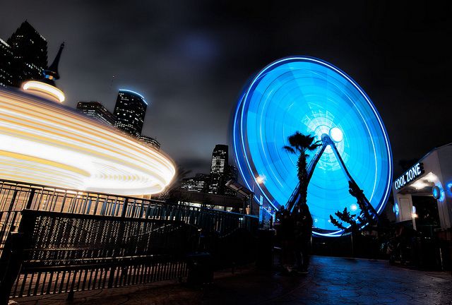 a ferris wheel in the middle of a city at night