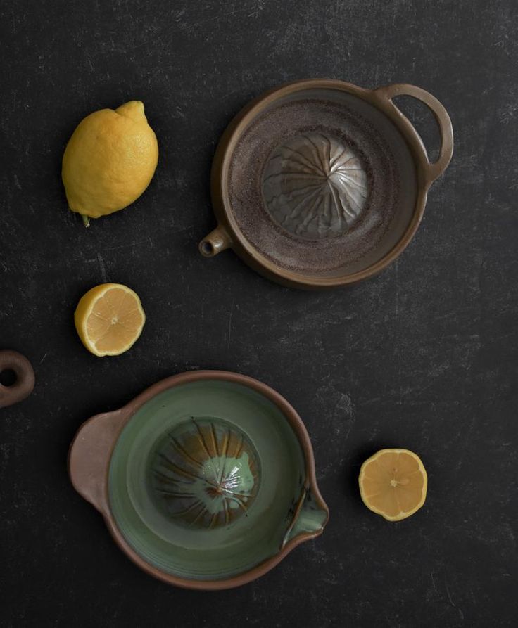 a tea set with lemons on the table