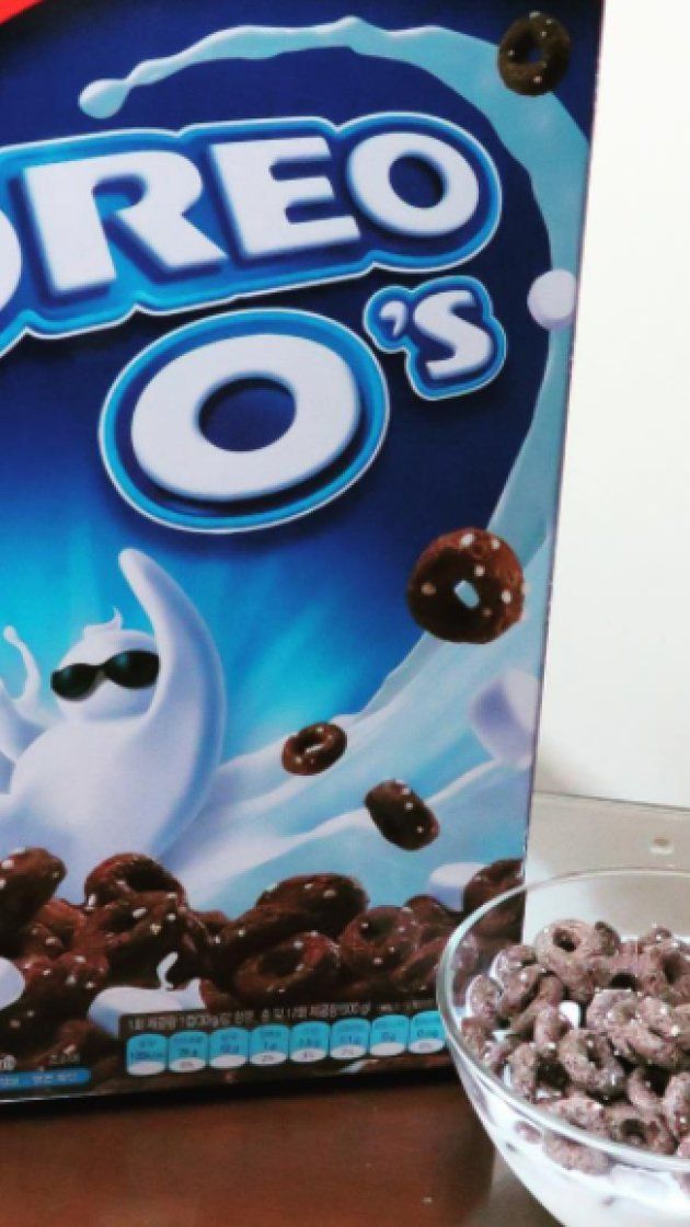 a box of oreo's cereal next to a bowl of doughnuts