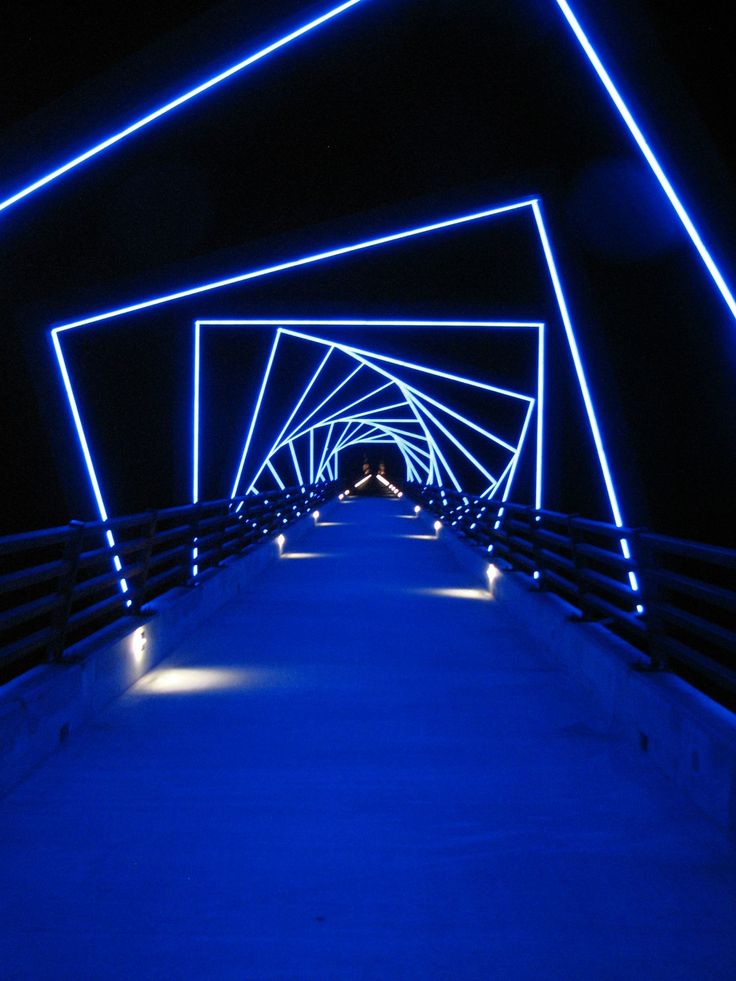 a long bridge with blue lights on it