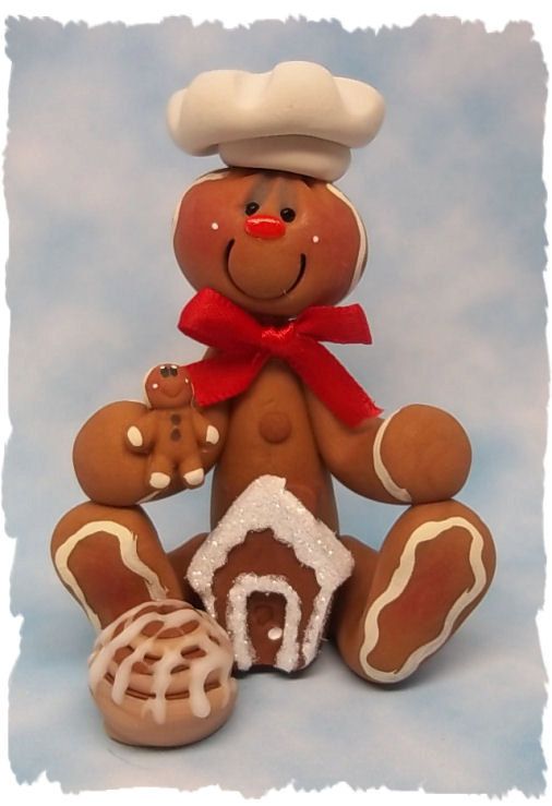 a ginger bear with a chef's hat and mitten is holding a cookie