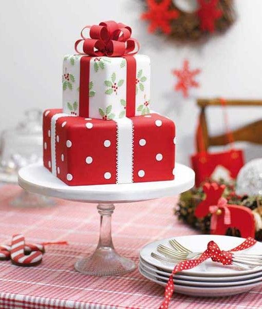 a three tiered cake decorated with red and white bows