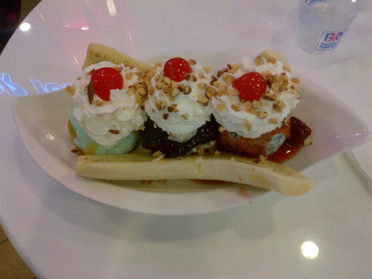 a banana split topped with whipped cream and toppings