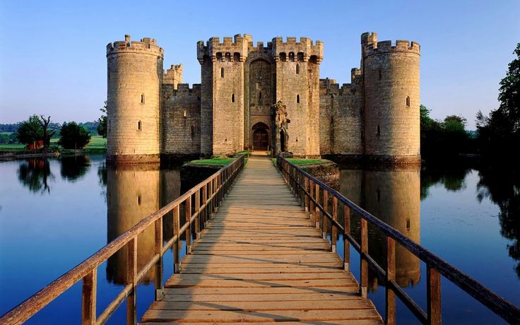 a bridge leading to a castle on the water