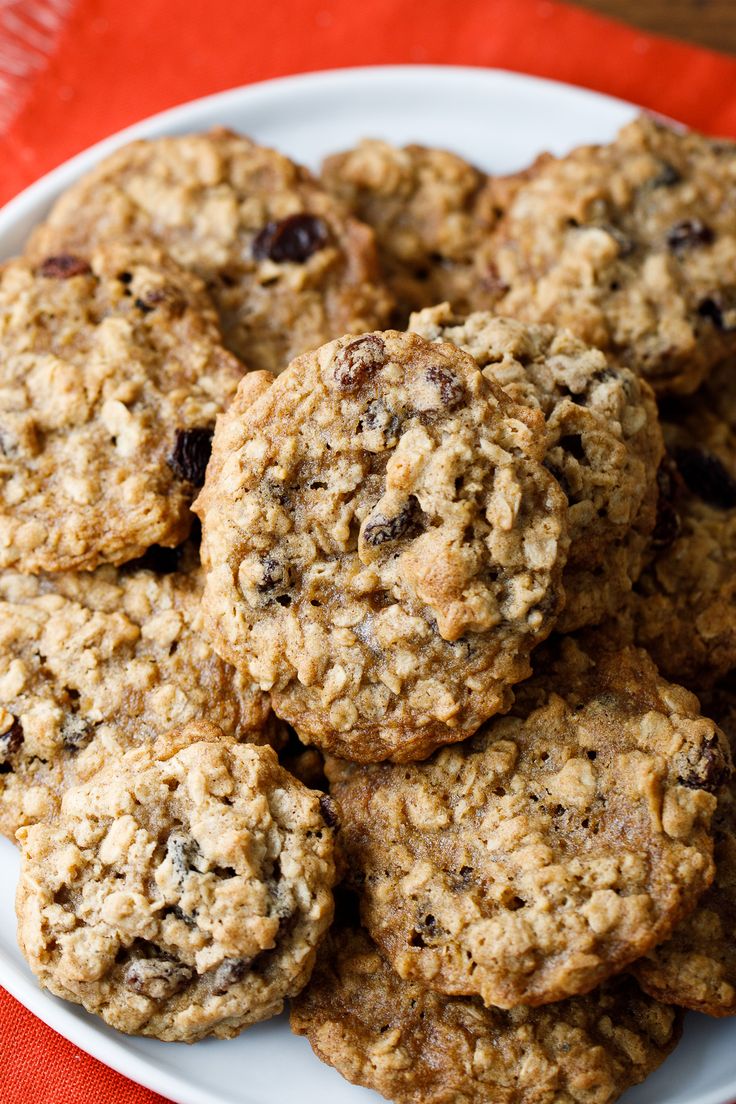 a white plate filled with oatmeal cookies on top of a red table cloth