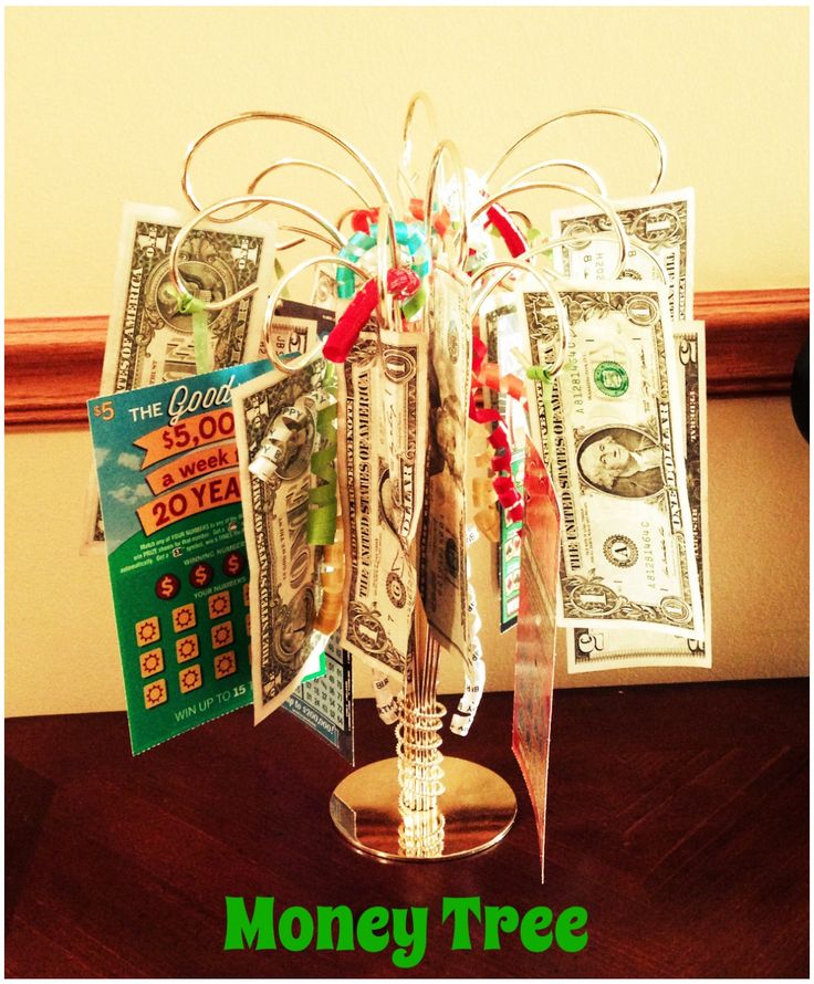 money tree made out of dollar bills on top of a wooden table with the words money tree written below it