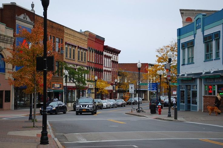 an empty street with cars parked on both sides