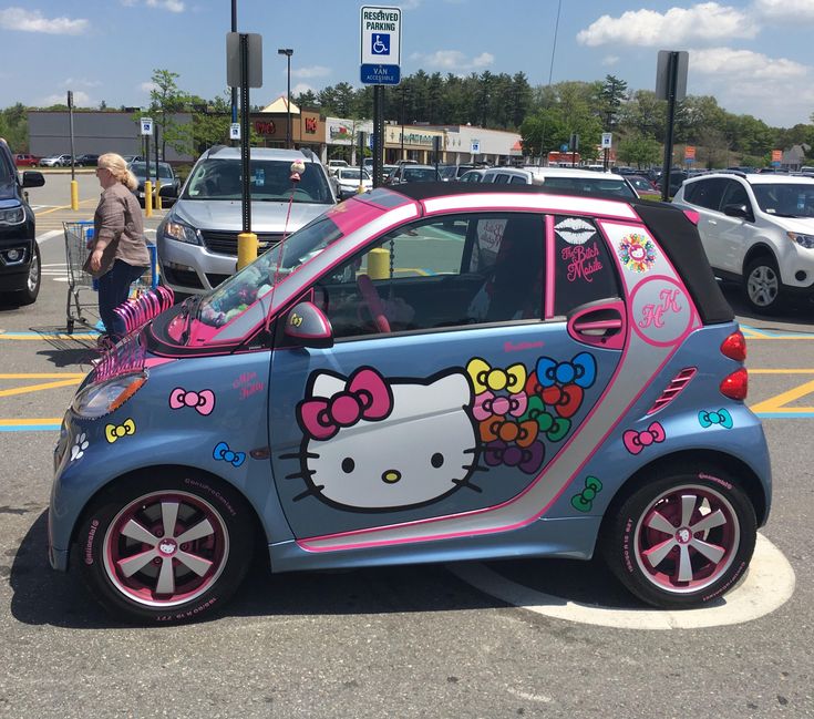 a hello kitty car parked in a parking lot