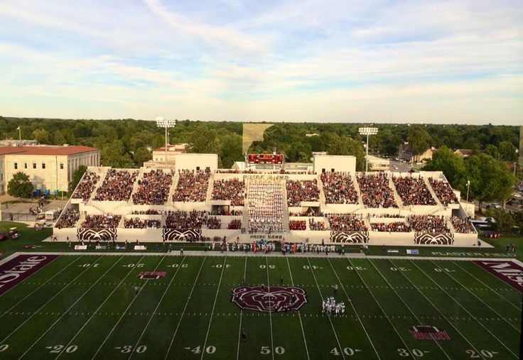 an aerial view of a football stadium with the sun shining on it's field