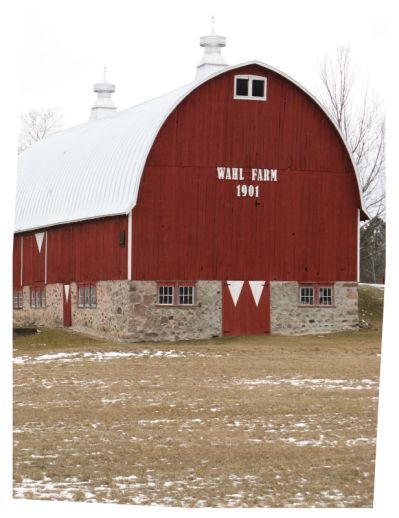 a large red barn with white trim and windows