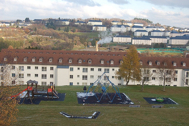 an aerial view of a playground and buildings in the background