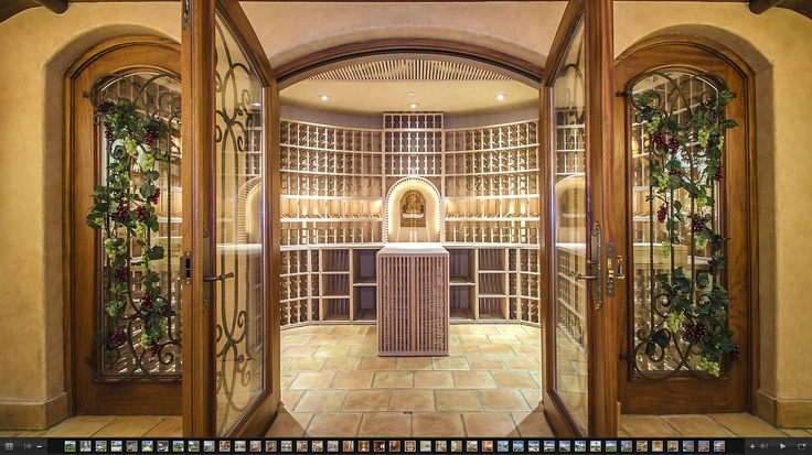 the inside of a wine cellar with glass doors