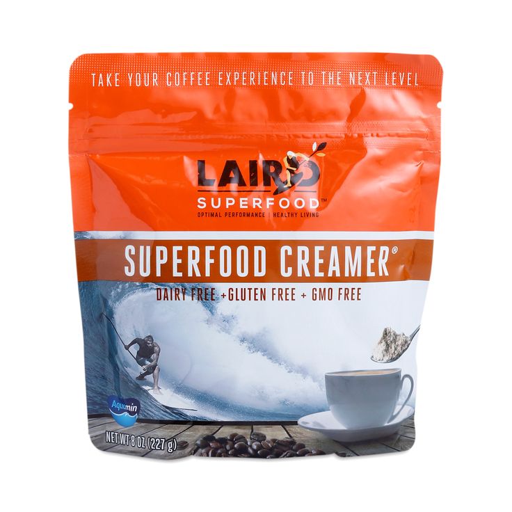 a bag of superfood creamer next to a cup of coffee