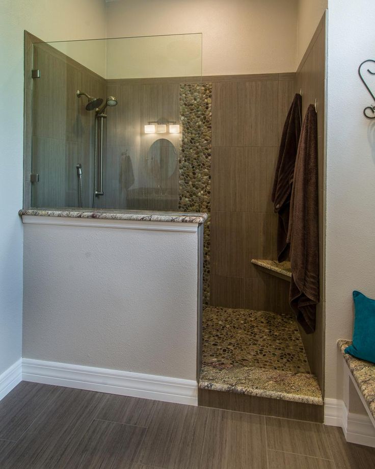 a walk in shower sitting inside of a bathroom