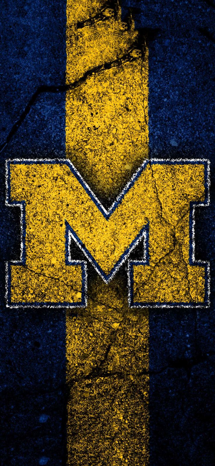 the michigan wolverines logo is painted on an old brick wall with blue and yellow stripes