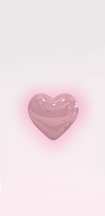 a pink heart shaped object floating in the air