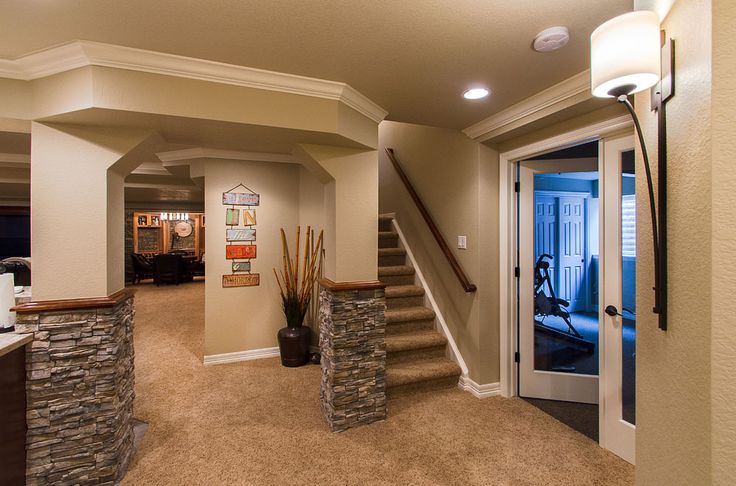 a living room filled with furniture and a staircase