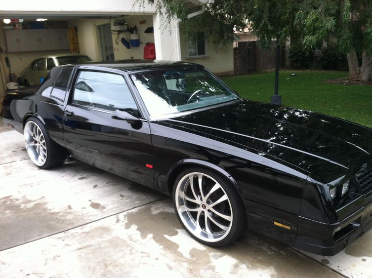 a black car parked in front of a house