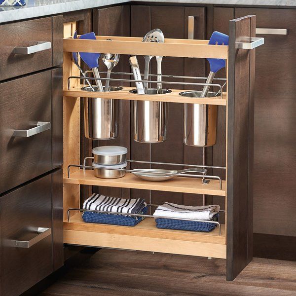 an open cabinet in a kitchen with utensils and pans on the shelves