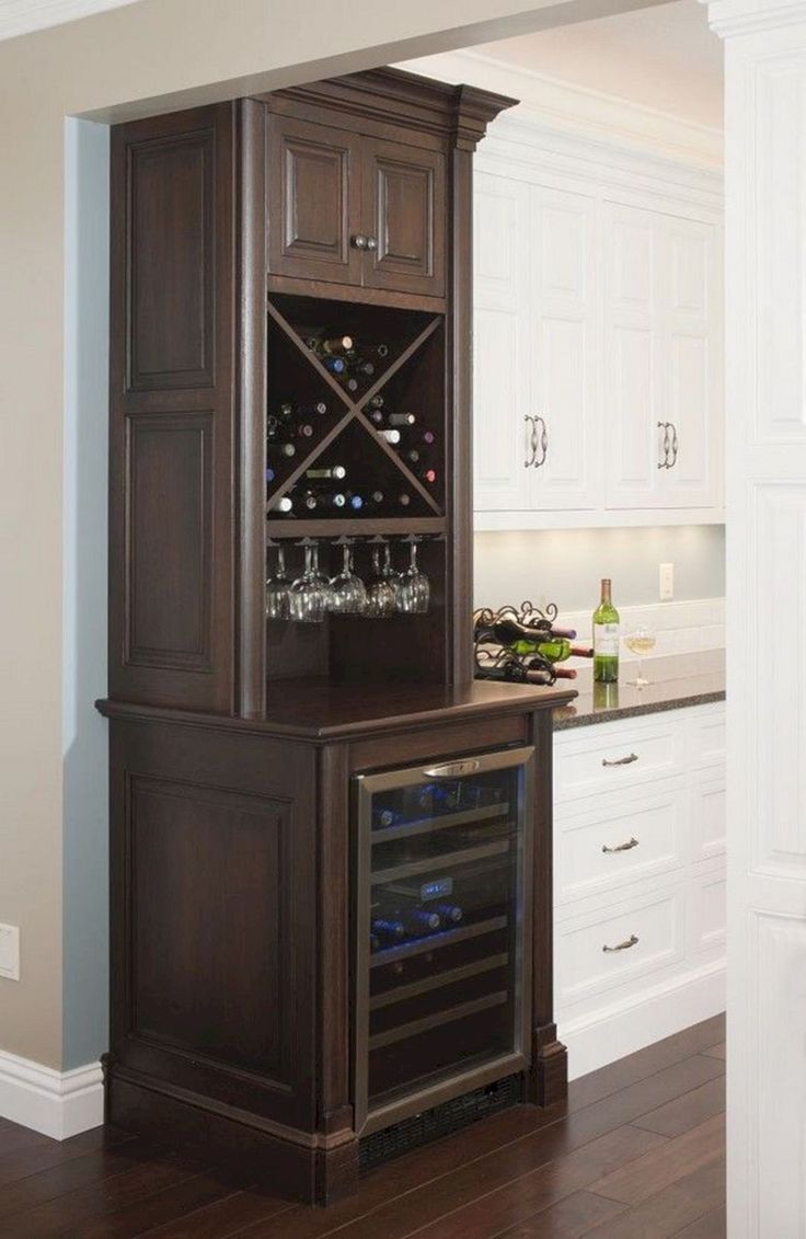 a wine cabinet in the middle of a kitchen