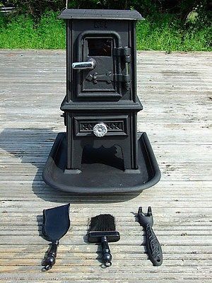 an old fashioned stove sitting on top of a wooden deck