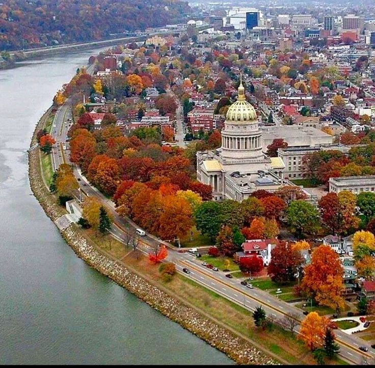 an aerial view of the capital building in washington d c, with fall foliage surrounding it