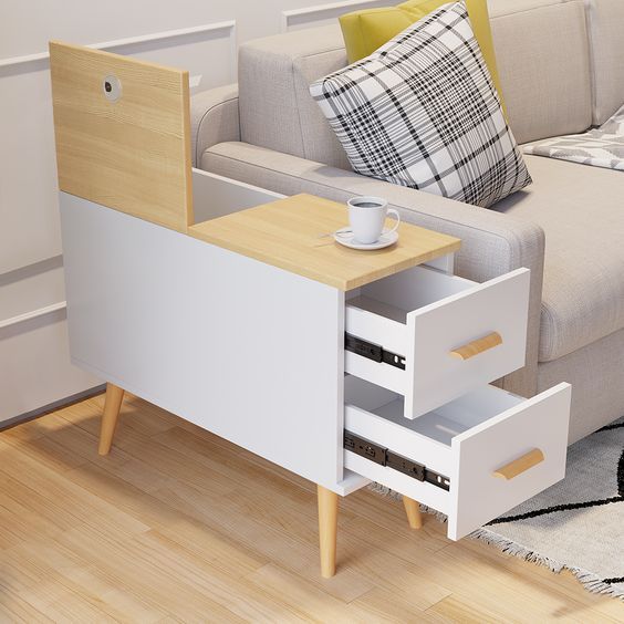 a coffee table with two drawers in front of a couch and rug on the floor