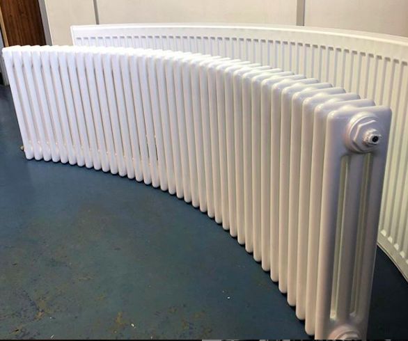 a large white radiator sitting on top of a blue floor