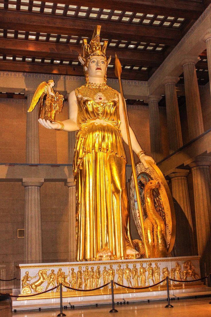 a large golden statue in the middle of a room