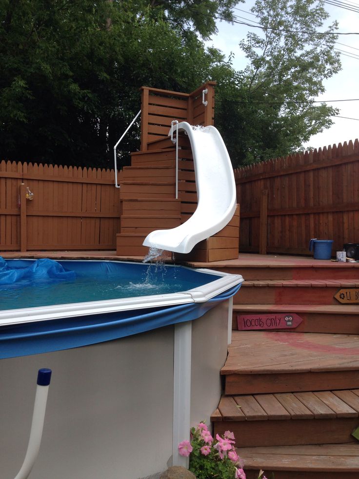 an above ground swimming pool with a slide in the middle and steps leading up to it