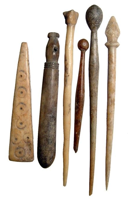 an assortment of old wooden tools on a white background