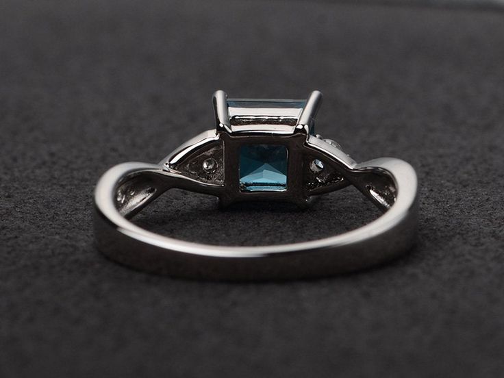 Welcome to my shop, you can find many beautiful gemstone jewelry here, and you also can ask for customized service. Main Stone: London blue topaz, princess cut, measures 6X6mm. Accent Stones: cz Metal: 925 sterling silver plated with rhodium. I also can provide metal options such as 14k solid yellow/white/rose gold Setting: prong setting more rings: https://www.etsy.com/shop/XCjewelryStudio?ref=hdr_shop_menu It's a perfect gift for the person who was born in November (Birthstone), it's quite com Elegant Princess Cut Topaz Ring With Cubic Zirconia, Elegant Princess Cut Topaz And Cubic Zirconia Ring, Elegant Square Cut Topaz Promise Ring, Elegant Silver Topaz Ring With Princess Cut, Elegant Silver Princess Cut Topaz Ring, Elegant Princess Cut Blue Topaz Ring, Formal Princess Cut Blue Topaz Ring, Blue Topaz Princess Cut Promise Ring, Princess Cut Blue Topaz Ring For Promise