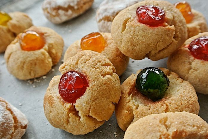 some cookies with jelly on them are sitting on a table