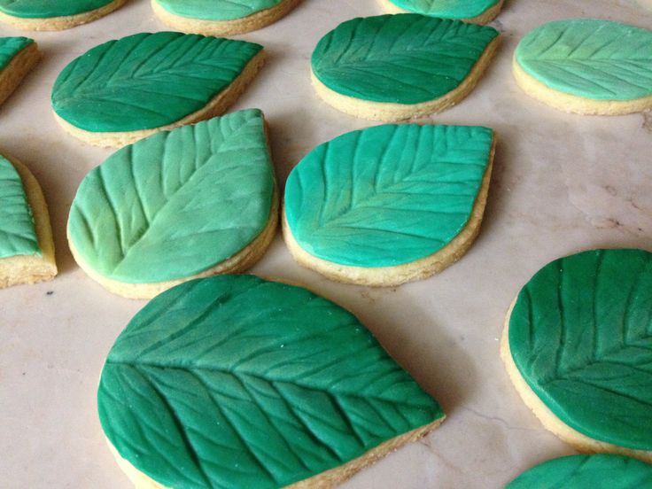 cookies decorated with green leaves on a table