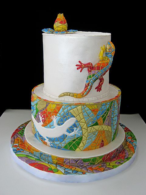 a three tiered cake decorated with colorful designs