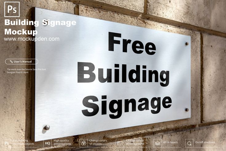 a free building sign mounted to the side of a brick wall