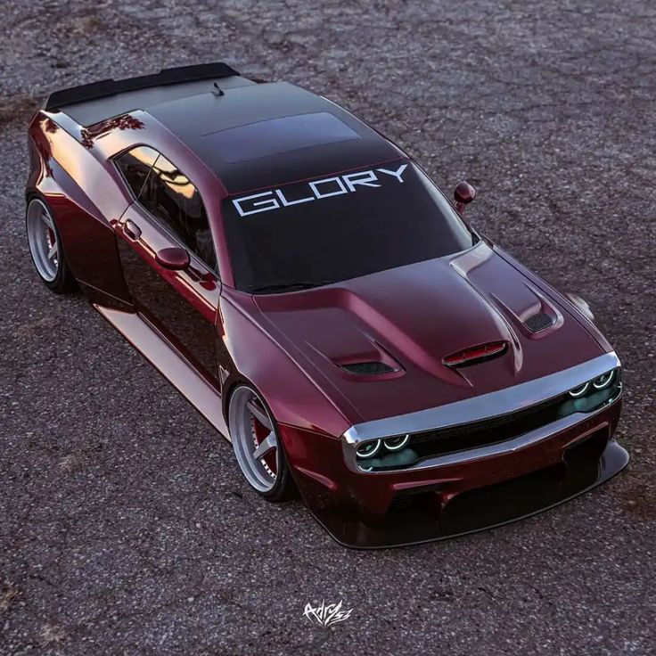 a red sports car with the word glory written on it's hood is shown from above