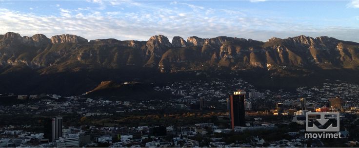 a city with mountains in the background