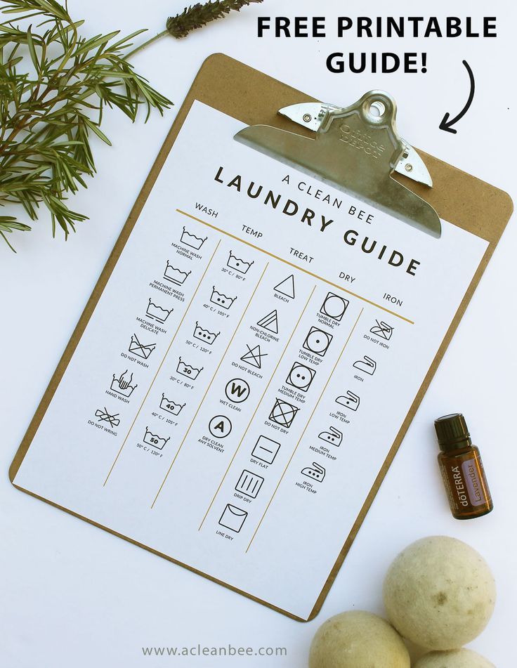 a free printable laundry guide is shown on a clipboard next to some rocks