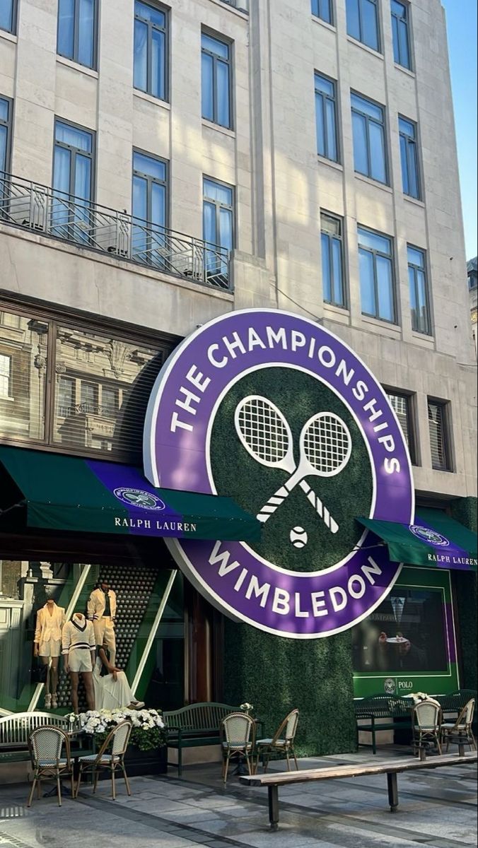 the sign for wimbledon has two tennis racquets hanging from it's side