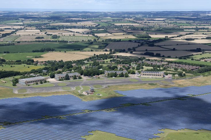 an aerial view of the countryside and farmlands with solar panels on it's sides