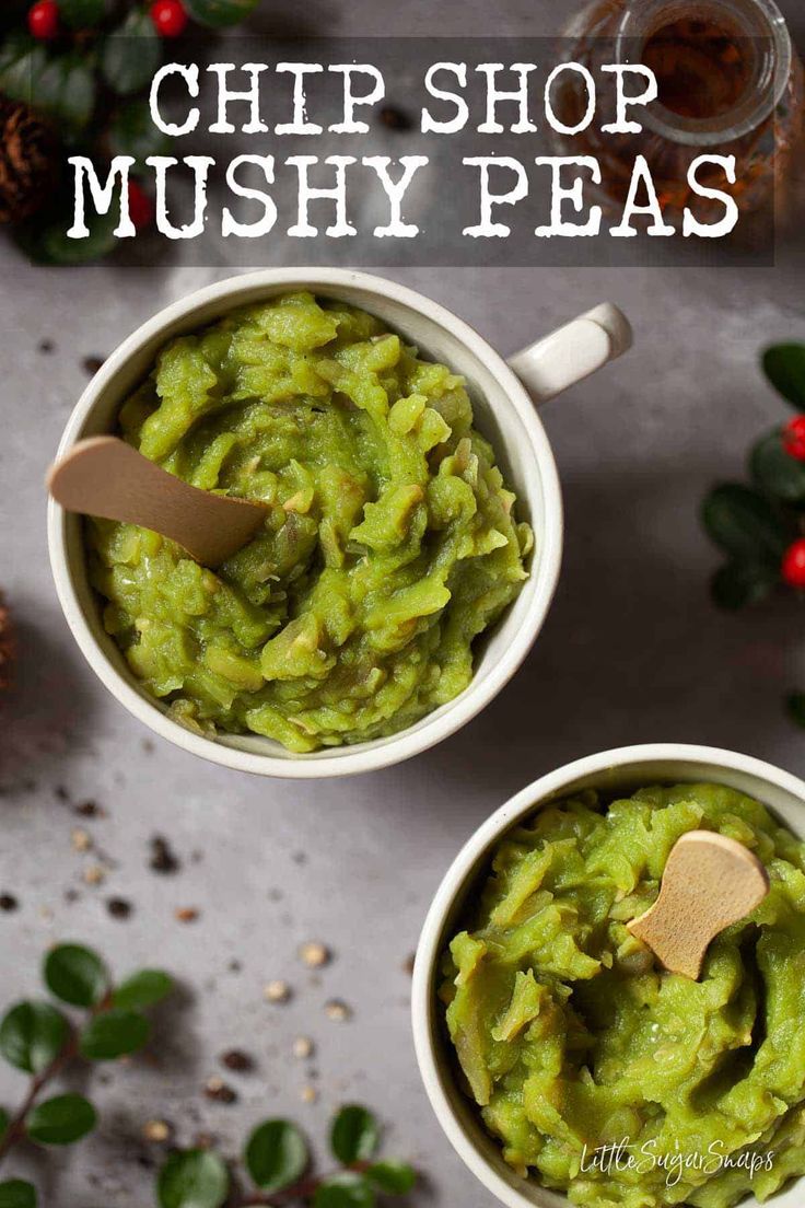 two white bowls filled with green guacamole and topped with a wooden spoon