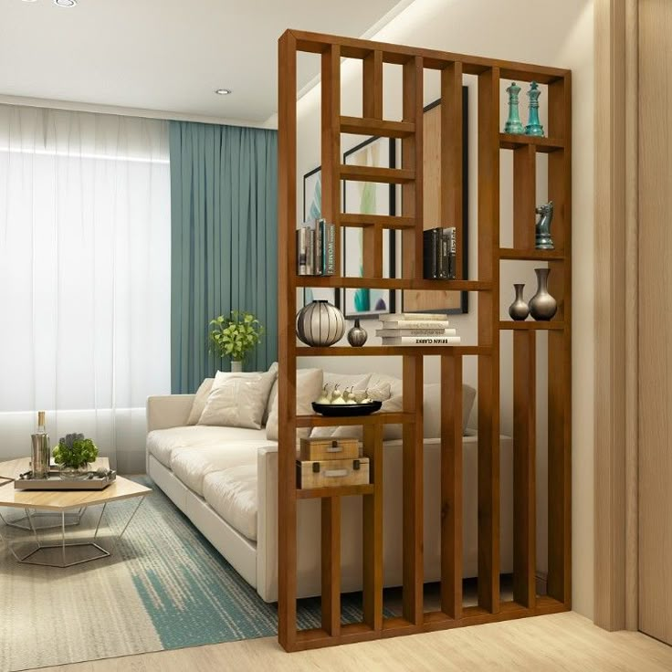 a living room filled with furniture next to a white couch and wooden bookshelf