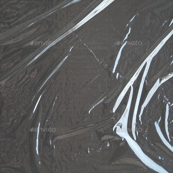 an aerial view of water and ice on the ground, with white lines running through it