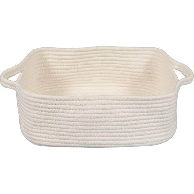 a white basket with rope handles on the bottom and sides, sitting in front of a white background