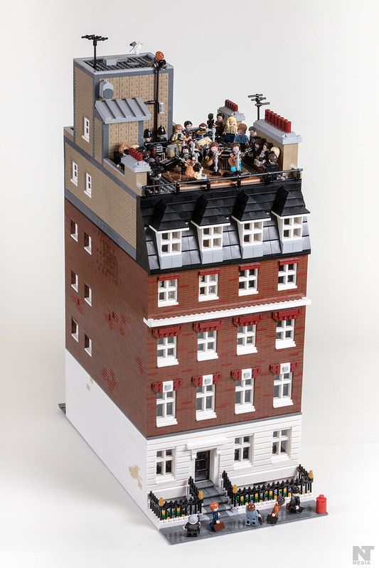 a building made out of legos with people on top